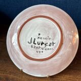 Terracotta plate, Jean Lurçat decorated with a character on a white background.