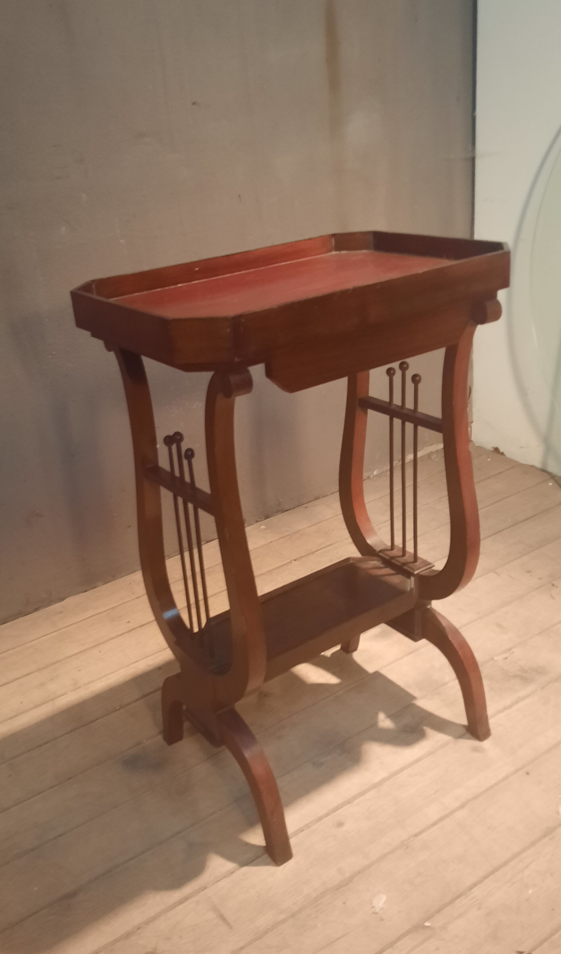 19th-century worker with a lyre footstool.