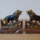 Small roaring lion bookends in patinated metal on a marble base.