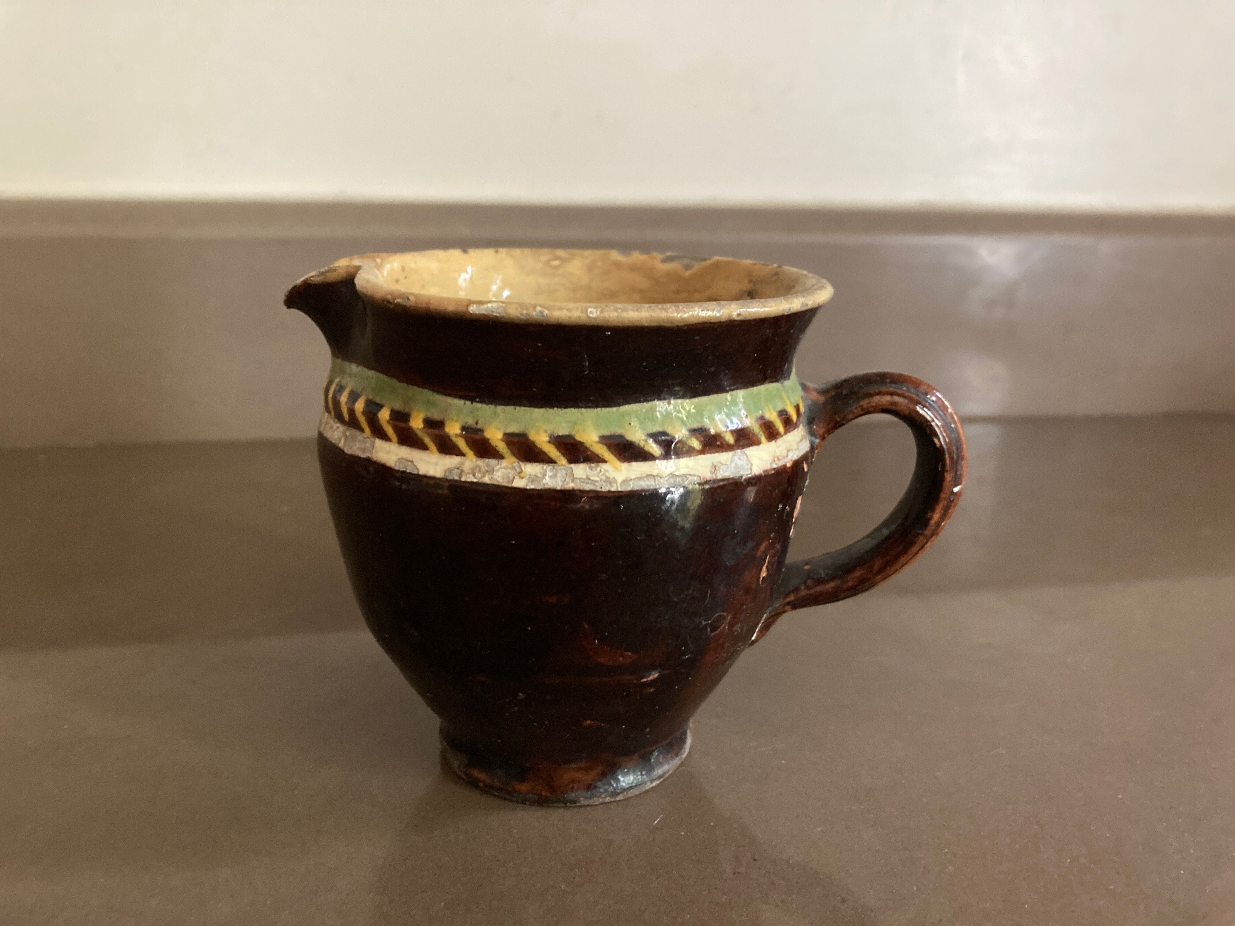 Antique pottery milk jug