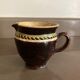 Antique pottery milk jug