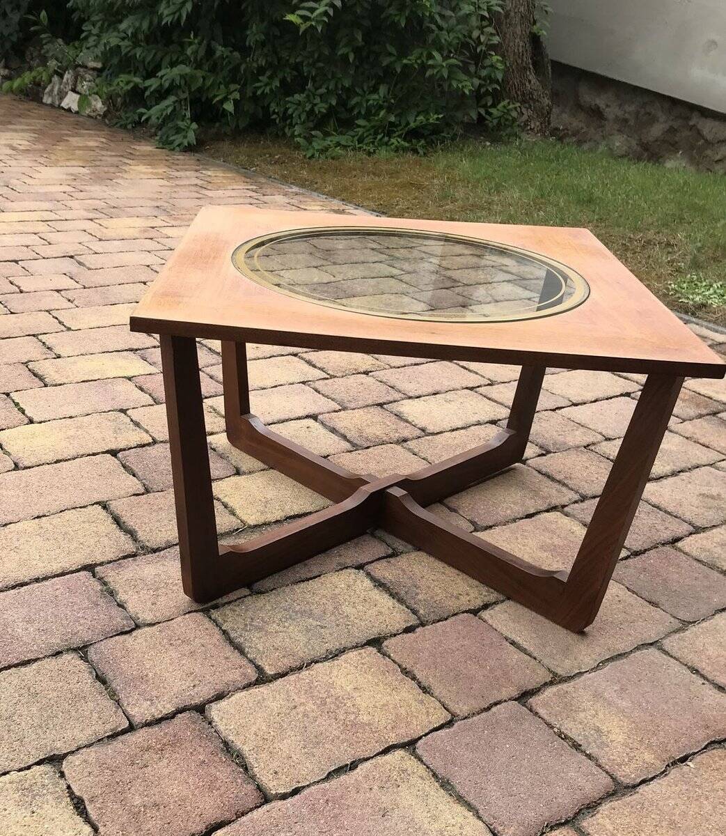 Round glass coffee table with a gold border and brown teak structure, Astro 1960s style.