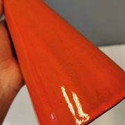 Ceramic table lamp with partial orange glaze.
