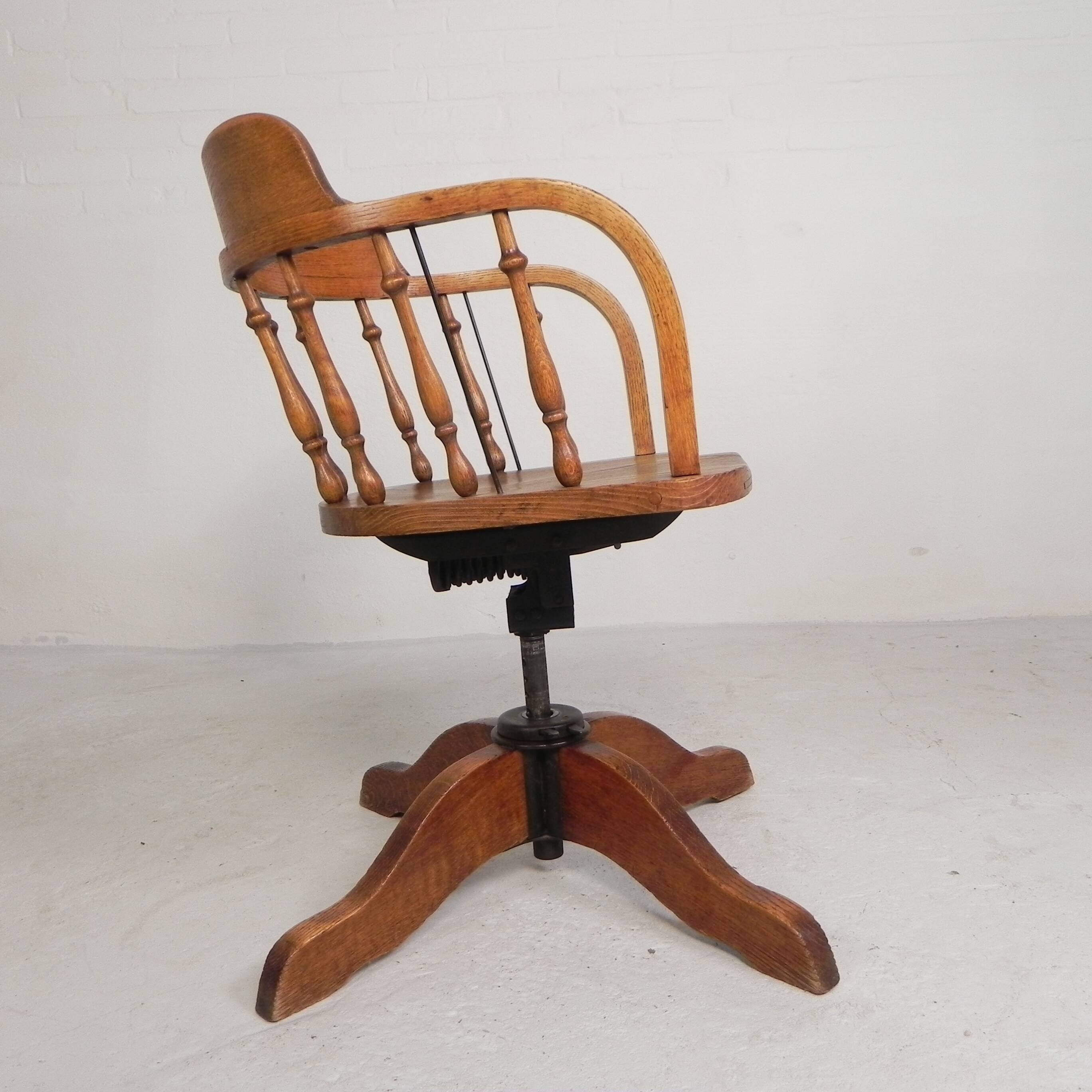 Oak office chair with a spring system and height adjustable, 1930s.