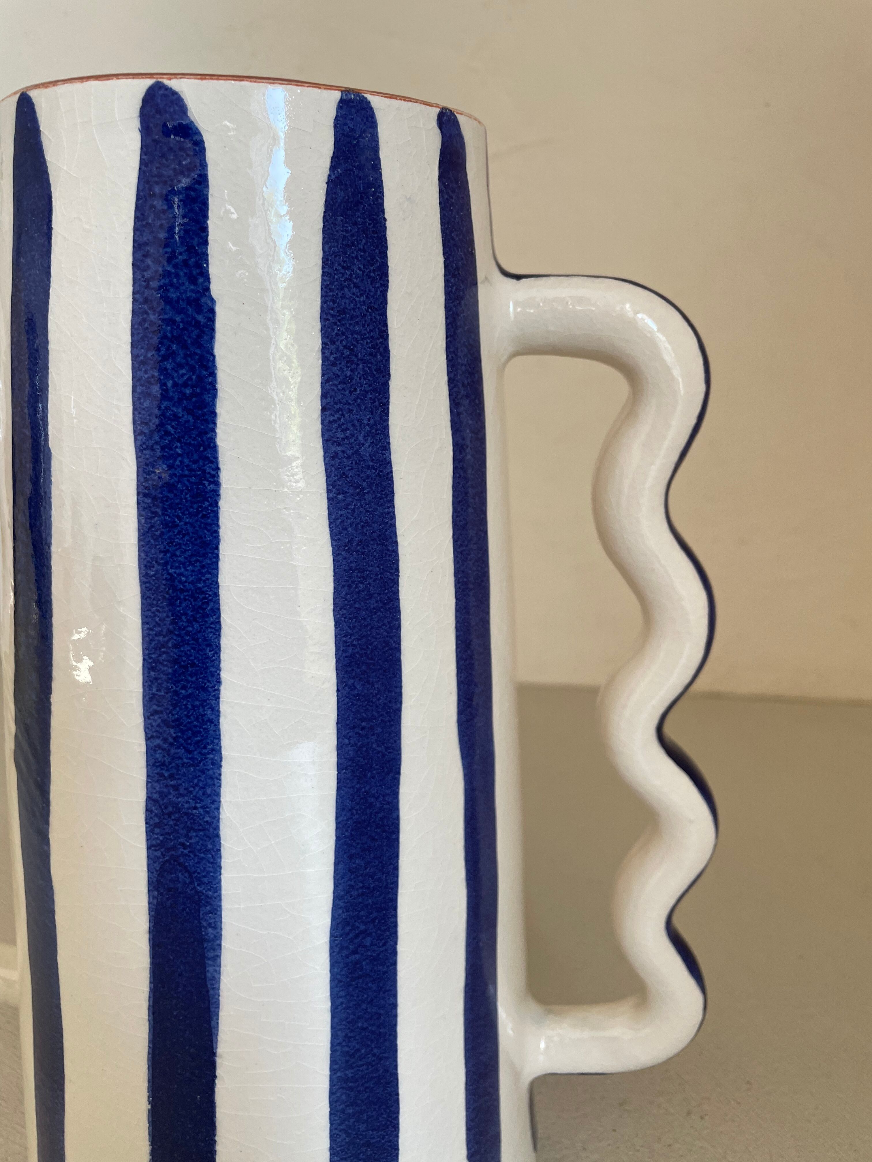Klein blue and white striped ceramic vase with abstract handmade wavy handles