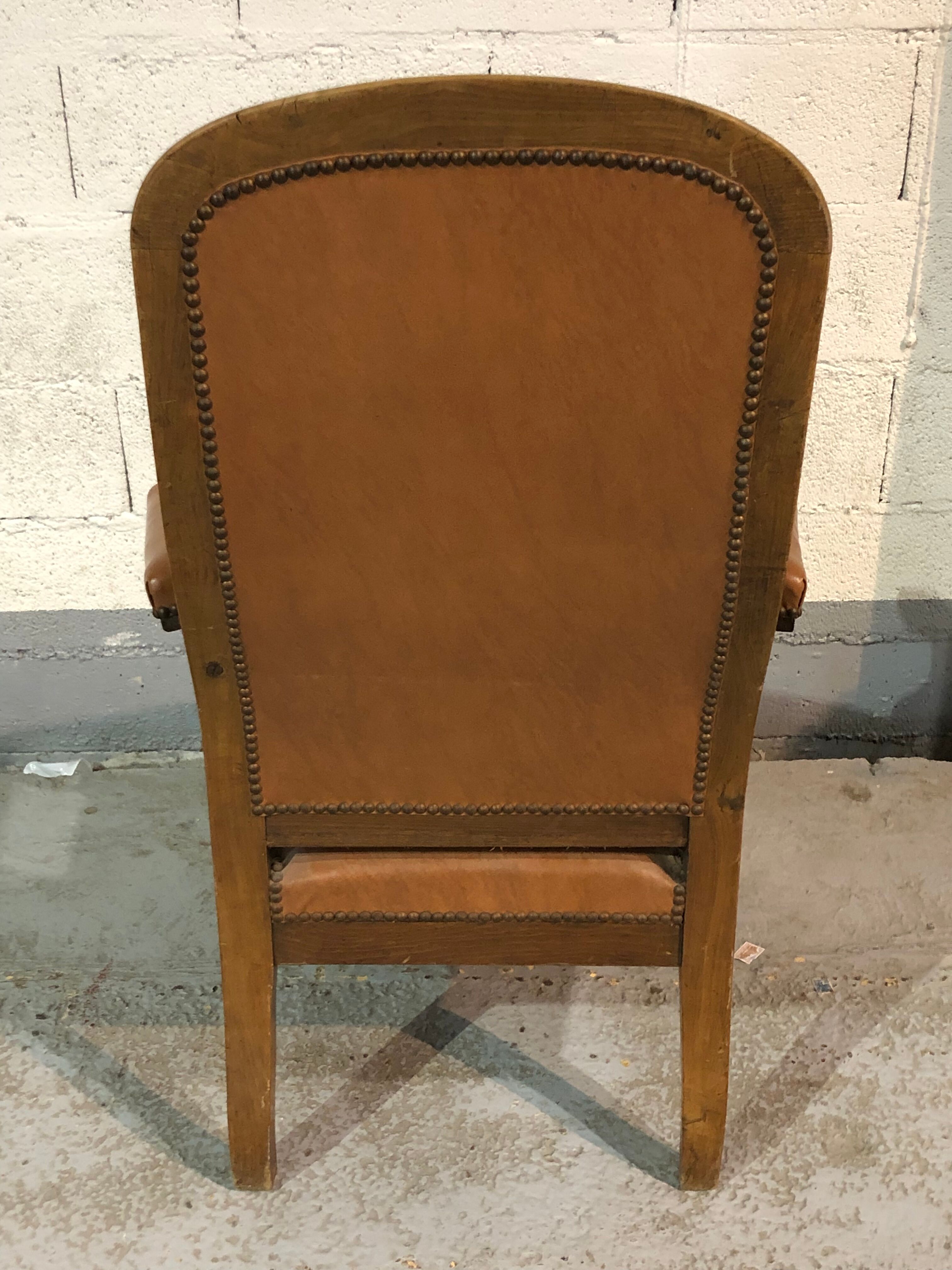 Old Voltaire armchair in light brown leather