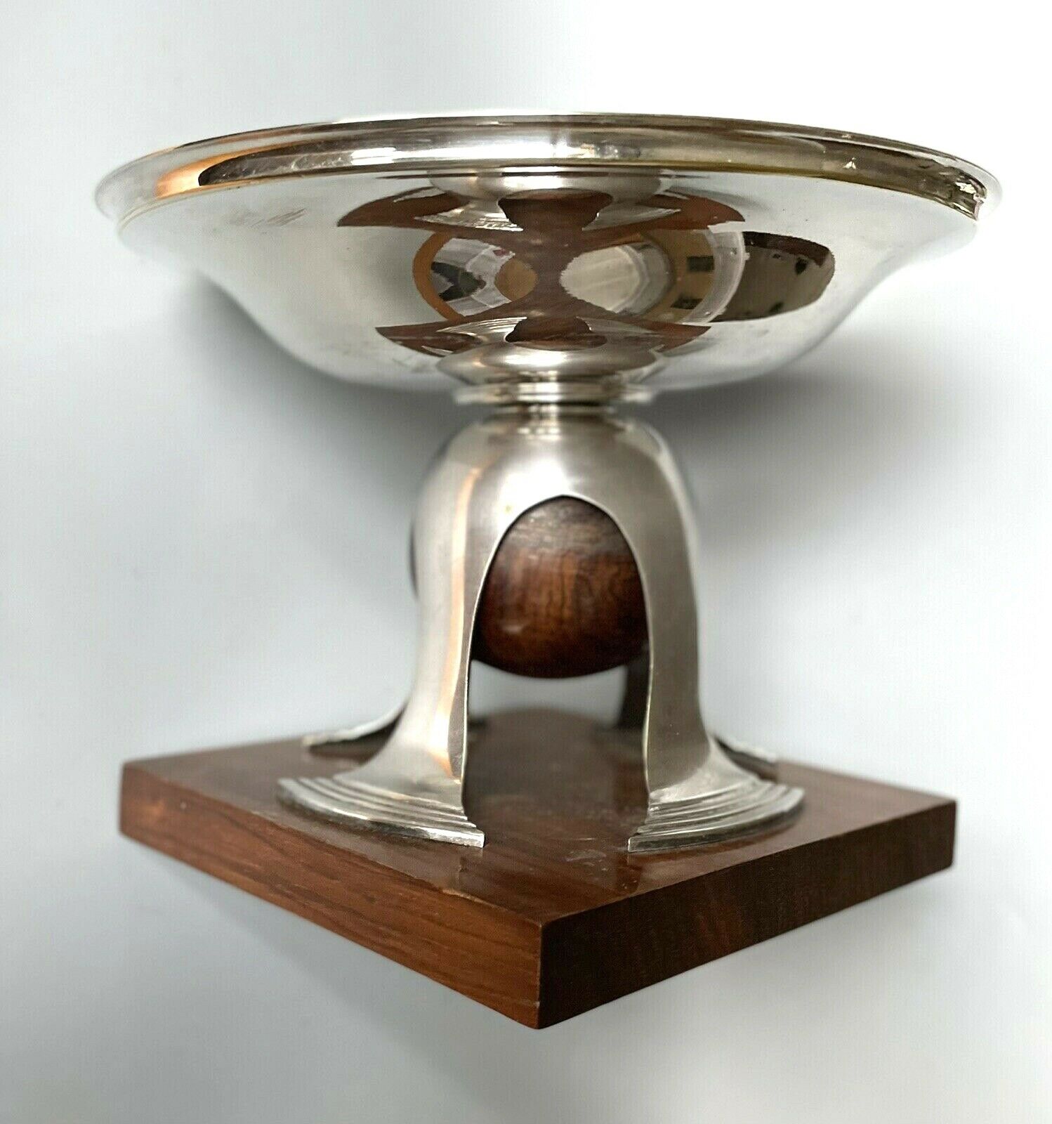 Art deco cut rosewood sphere enclosed in silver metal foot