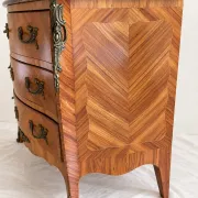 Curved Louis XV style commode in marquetry, veined marble and ornamentation.