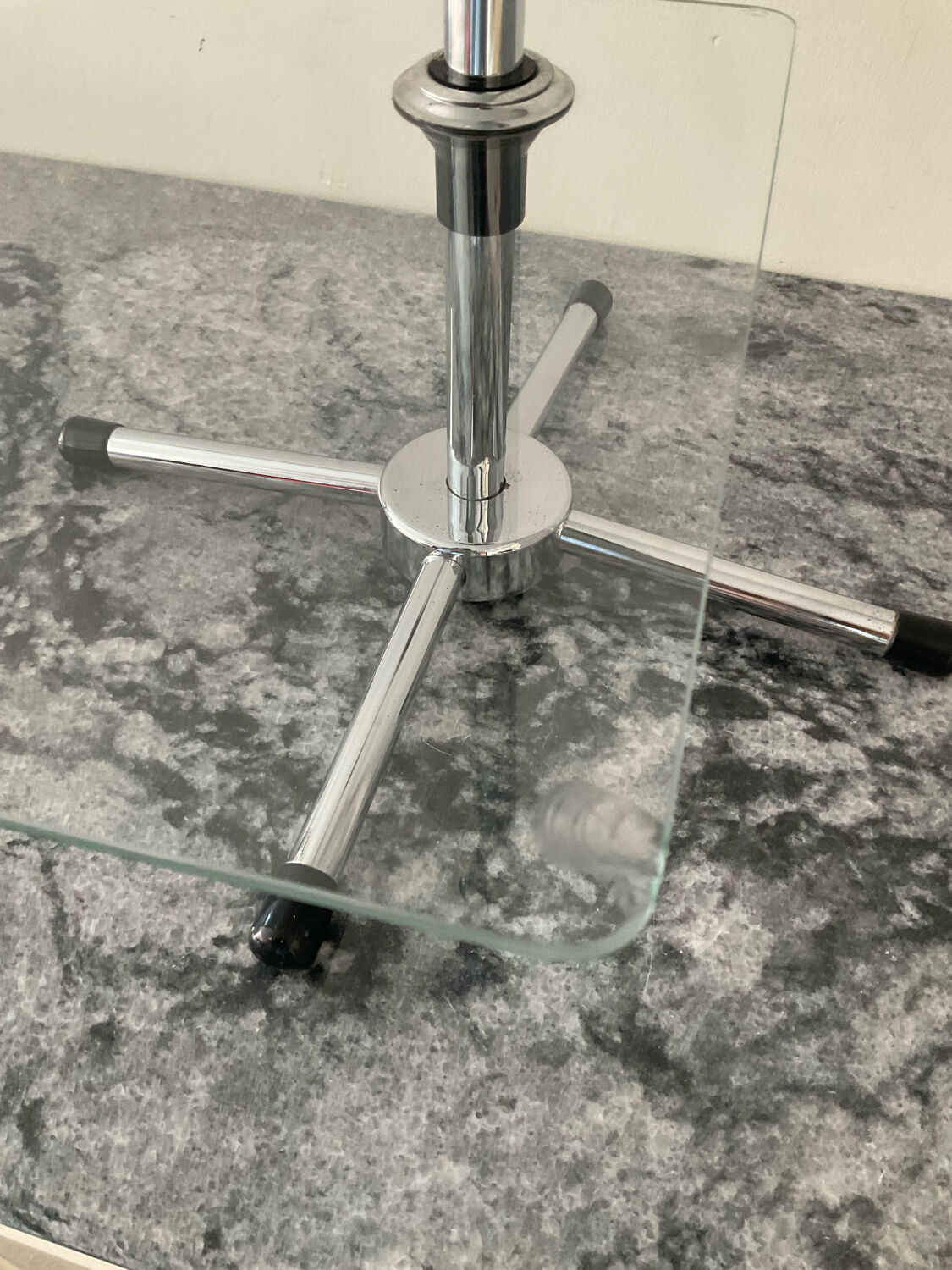 A pair of vintage side tables in glass and chrome metal.