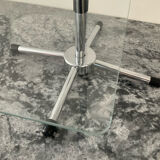 A pair of vintage side tables in glass and chrome metal.