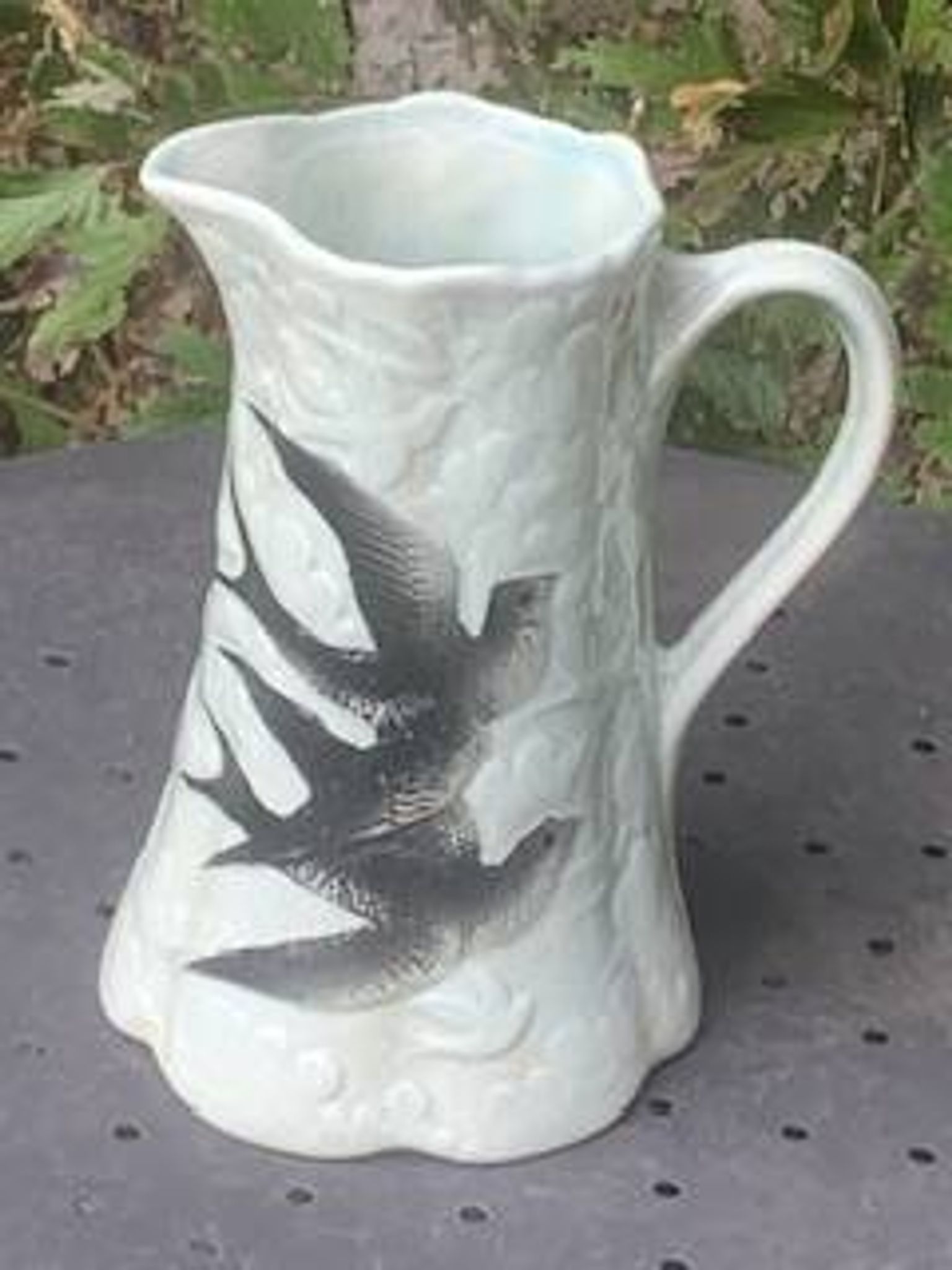 Jade green ceramic barbotine vase with swallows.