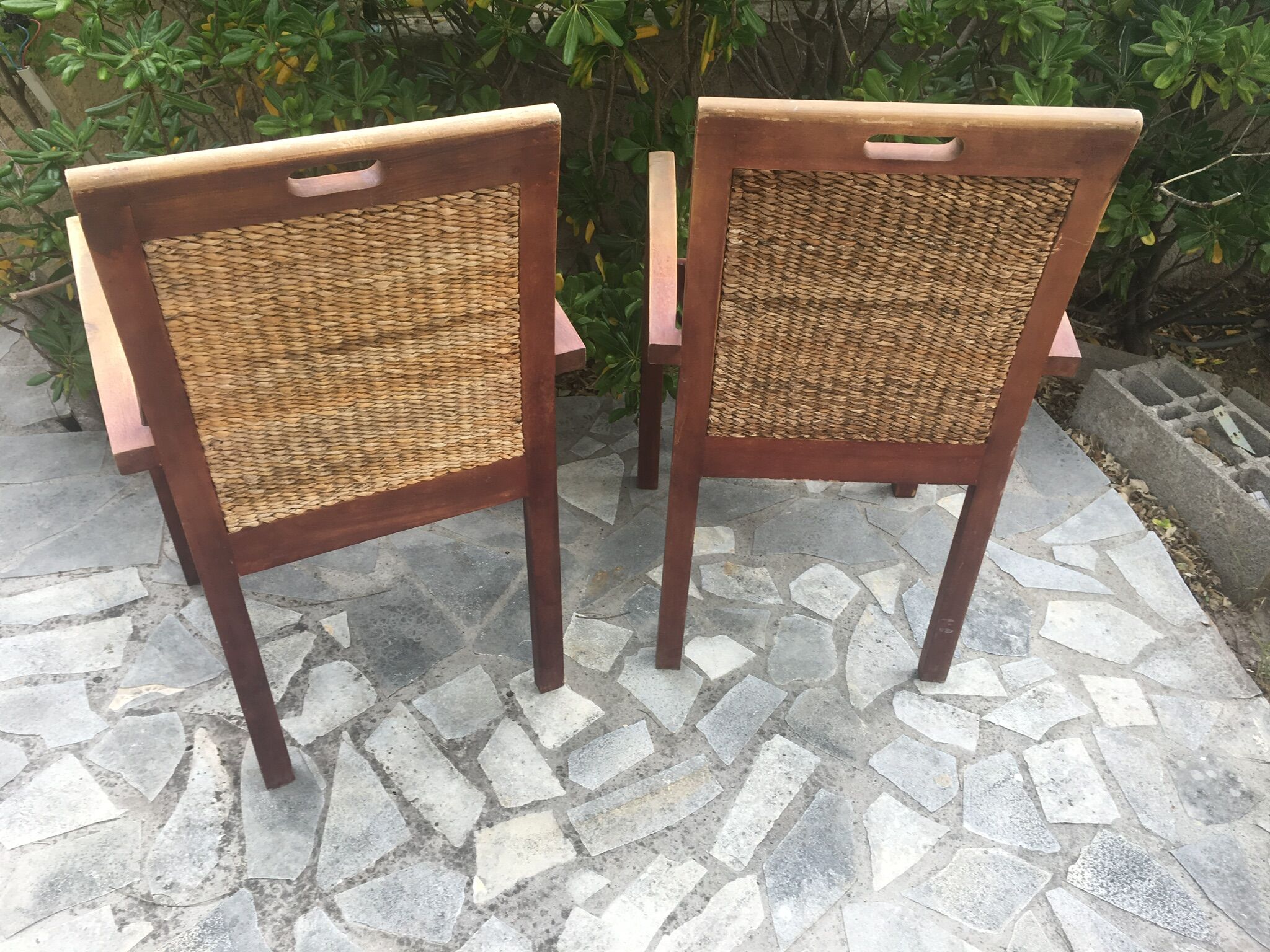 Pair of teak armchairs and braided wicker