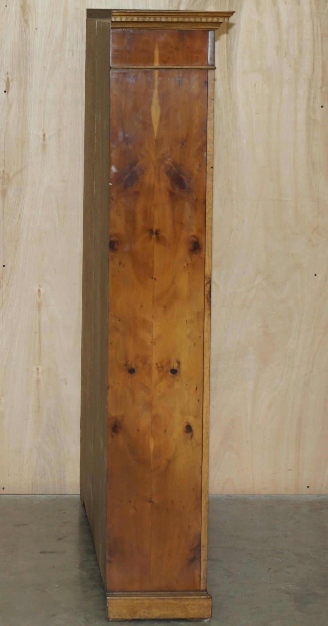 Pair of Sheraton Revival bookcases in satinwood, walnut, and yew.
