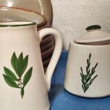 White ceramic pot and mini pitcher with bay leaf illustration
