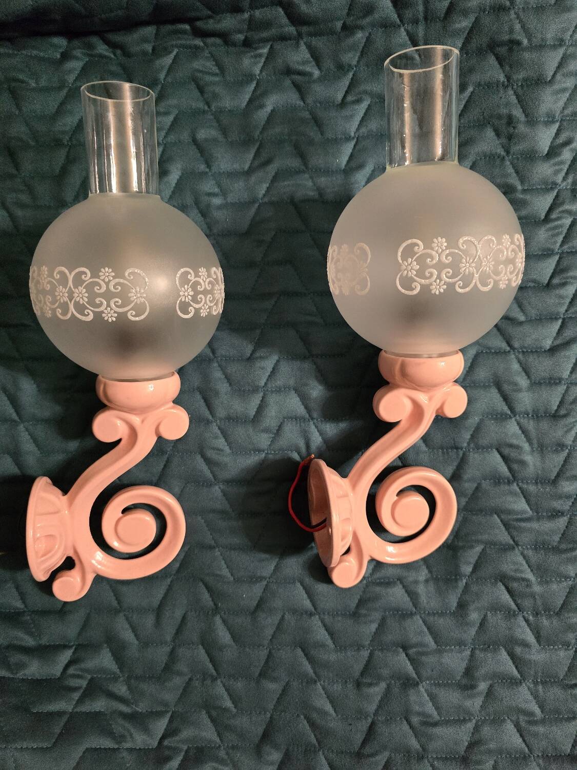 Original wall lights in pink enamelled cast iron with frosted glass globes.