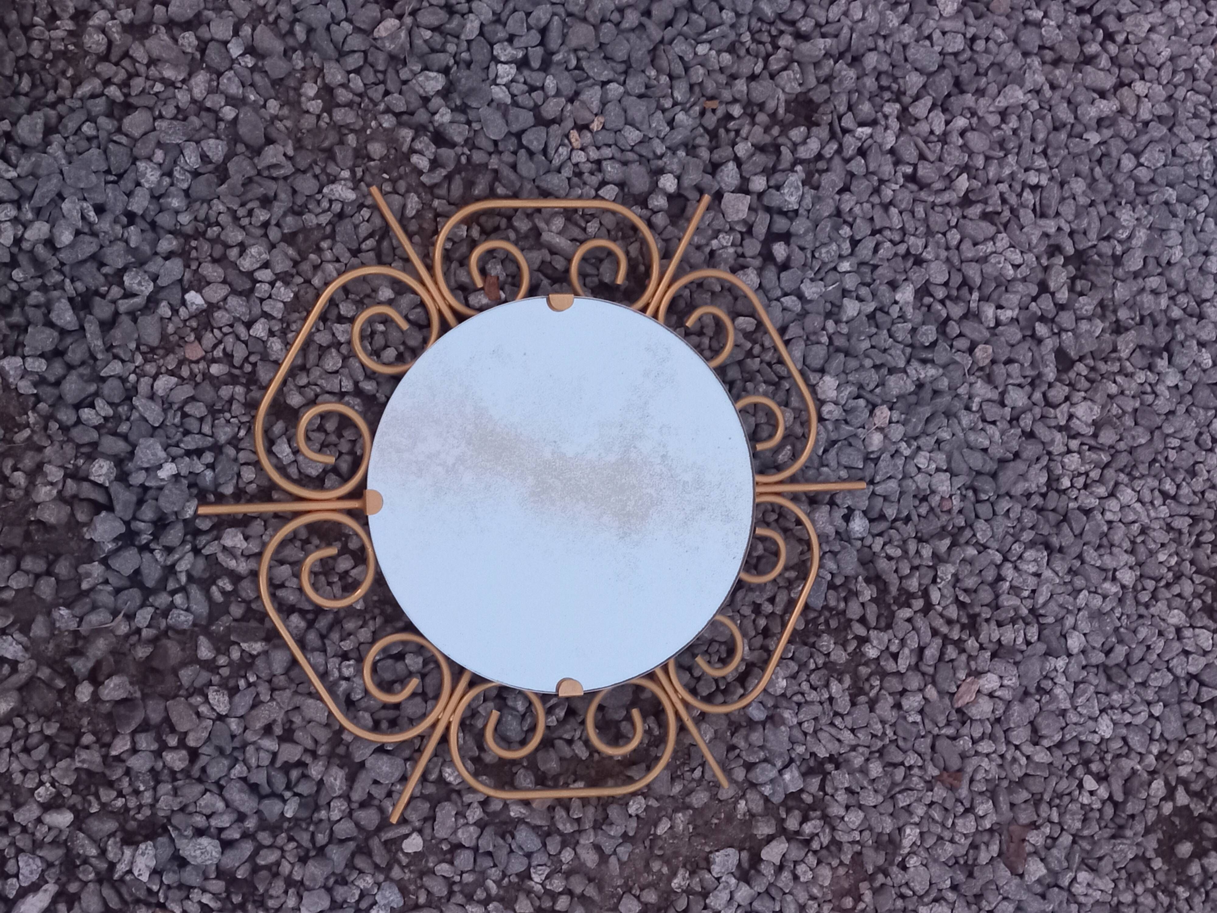 Golden metal sun mirror from the 1950s.
