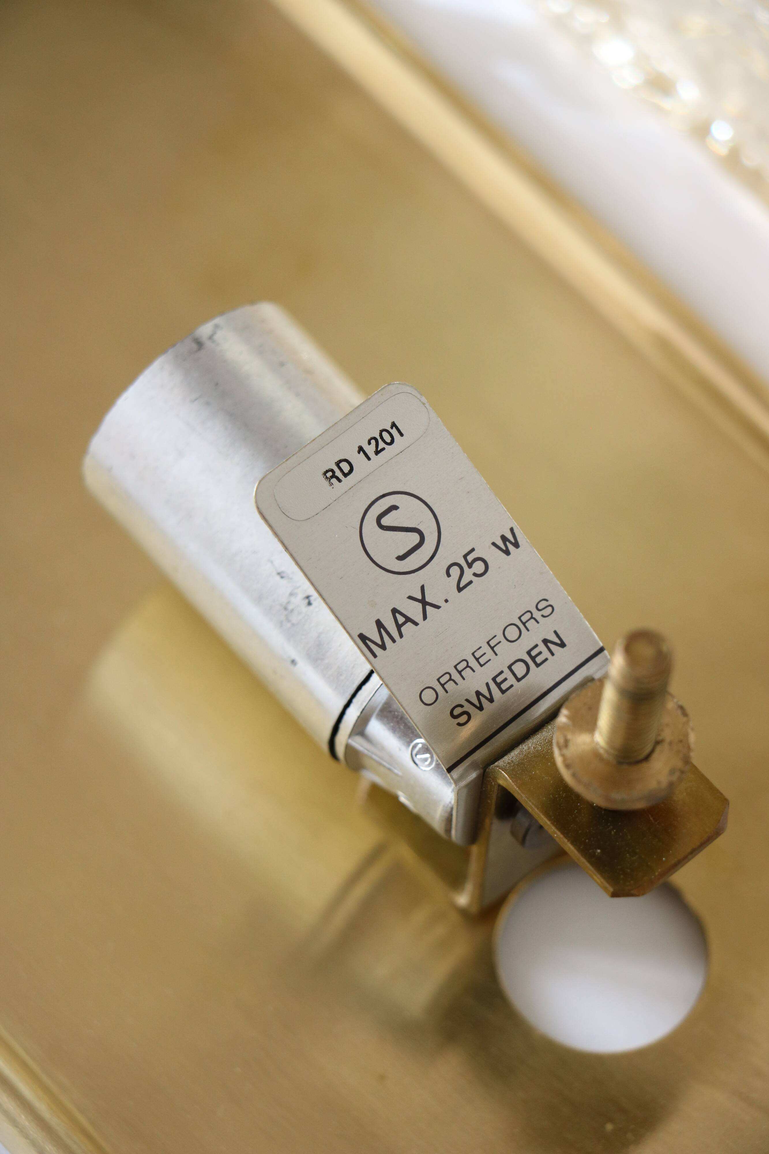 Glass and brass wall light by Carl Fagerlund for Orrefors, 1960.