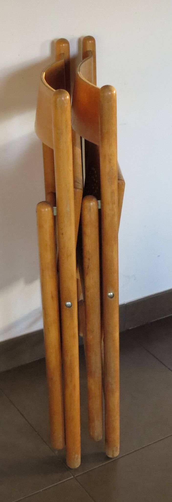 Pair of vintage wooden folding chairs with star pattern on seat