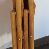 Pair of vintage wooden folding chairs with star pattern on seat