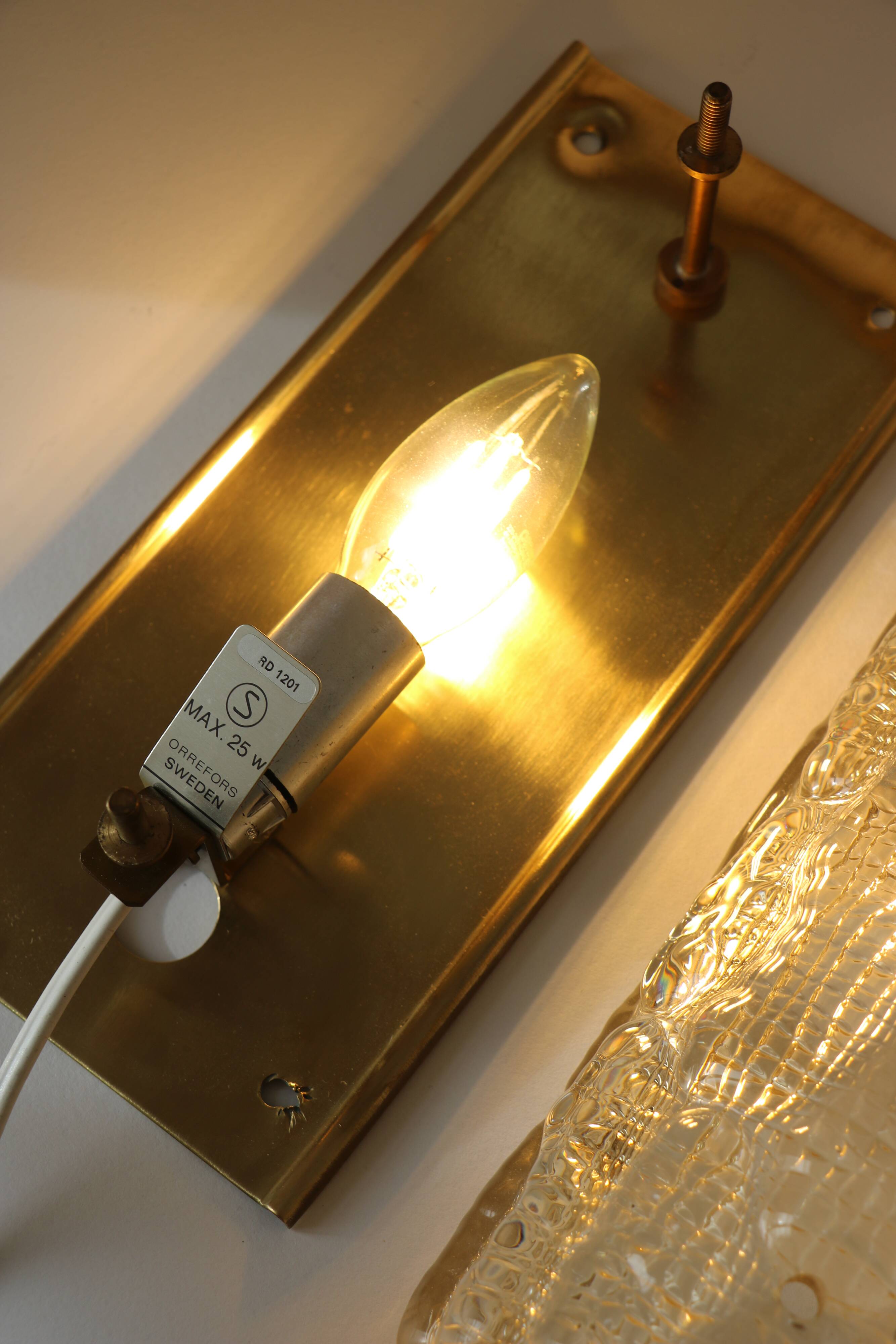 Glass and brass wall light by Carl Fagerlund for Orrefors, 1960.