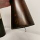 Two table lamps made of dark-stained wood with silver detail in the middle.
