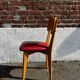 Set of 4 vintage bistro chairs in wood and red faux leather, with splayed legs.