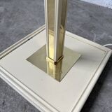 Floor lamp with articulated arm in brass-plated metal