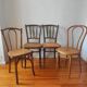 4 mismatched antique bistro chairs in wood and caning
