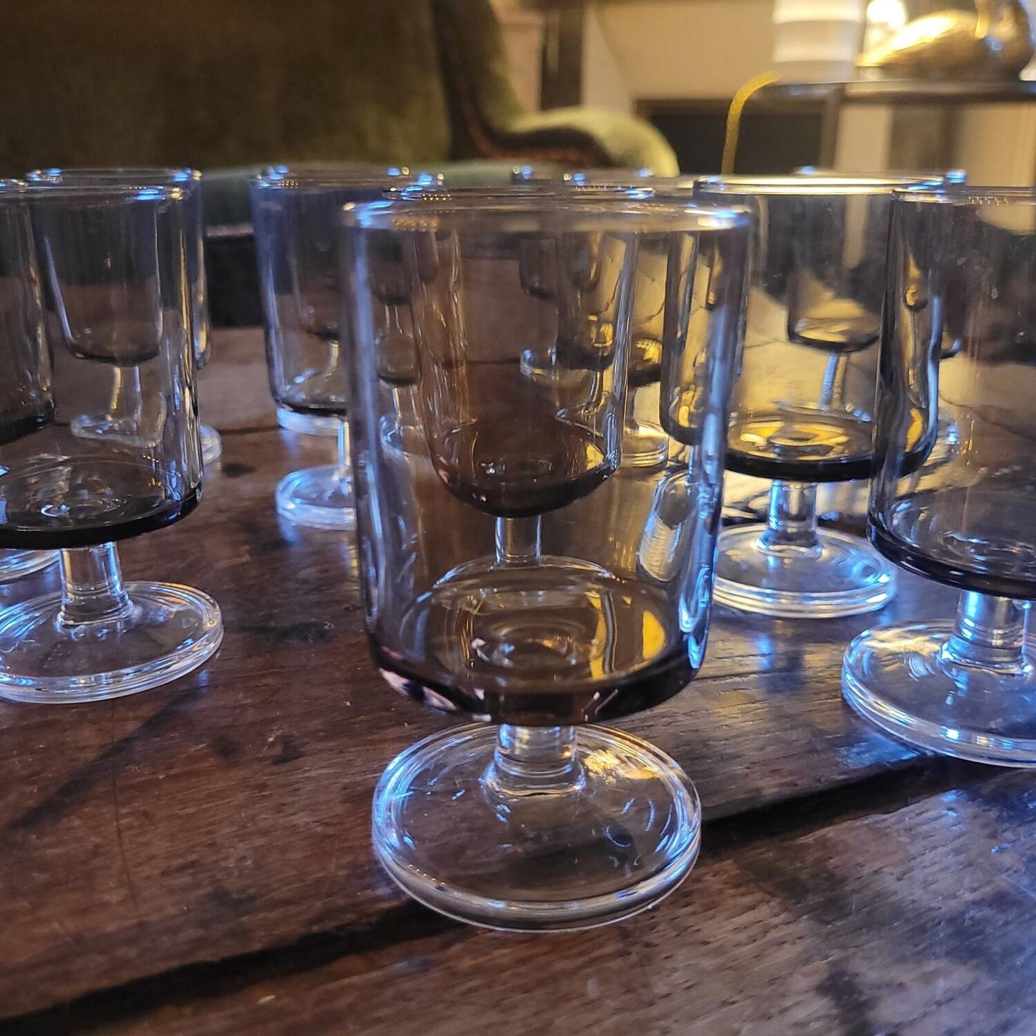12 smoked glass stemmed glasses from the 70s and 80s.