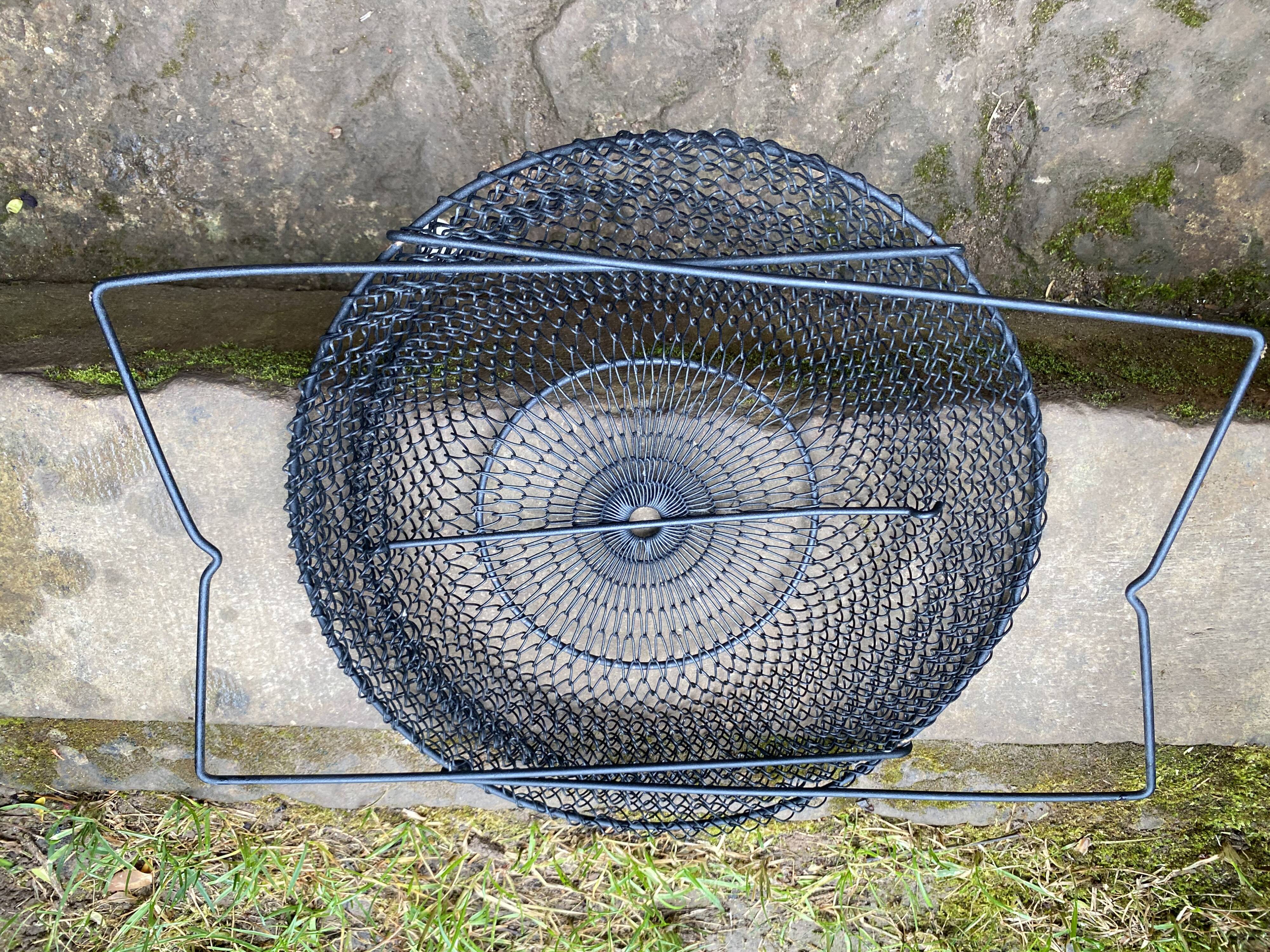 Foldable black woven metal wastepaper basket from around 1950.