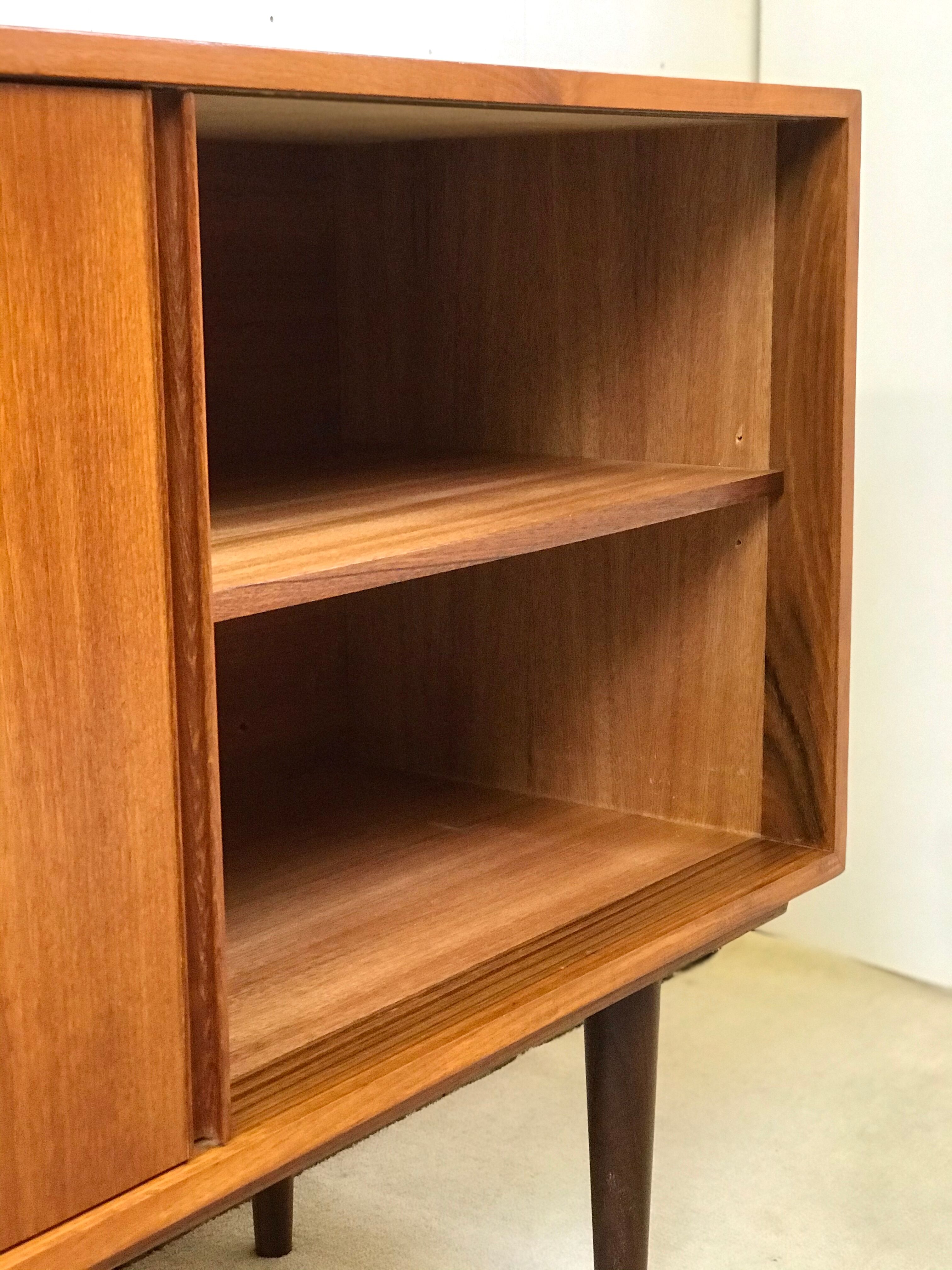 Danish teak sideboard with two sliding doors and 4 central drawers