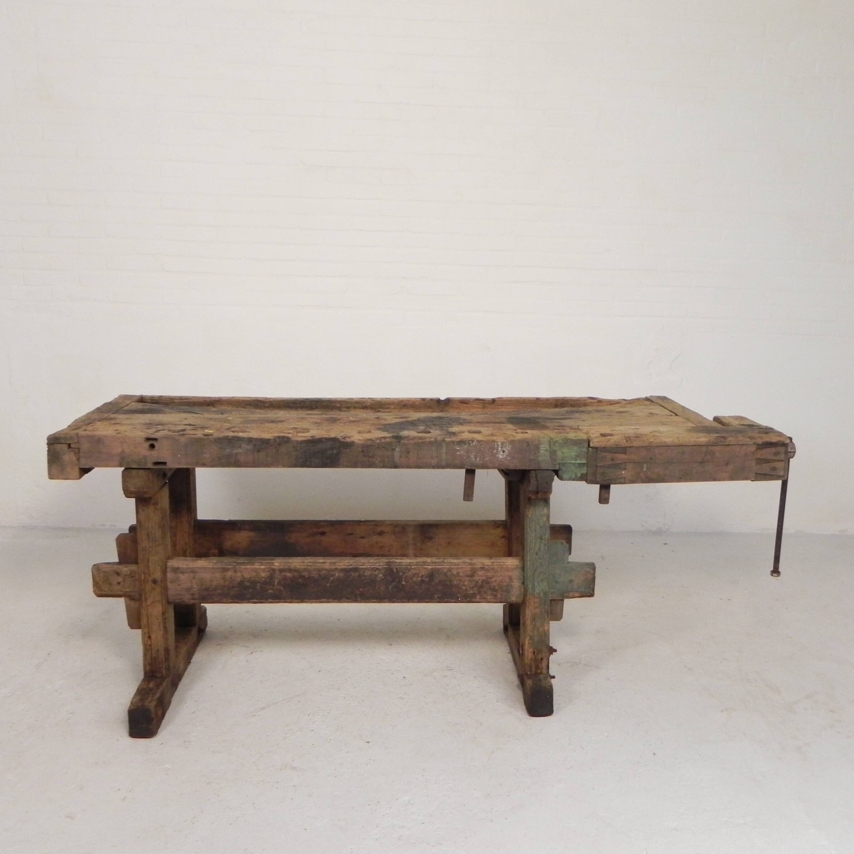 Wooden industrial workbench with vice, 194 cm long, 1930s.