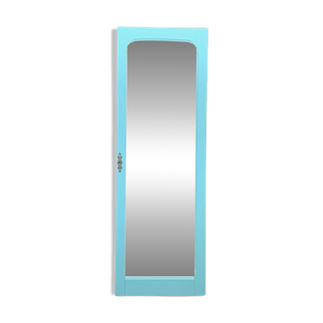 Beveled mirror on turquoise Parisian door