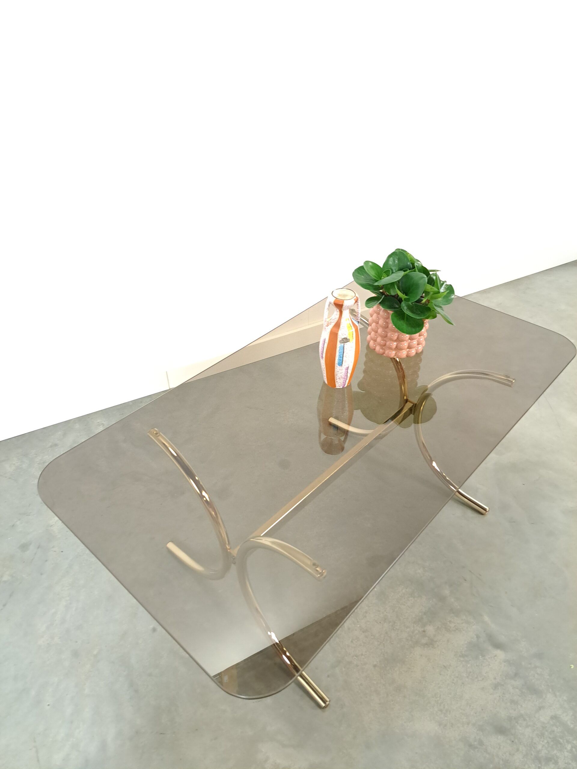 Smoked glass coffee table with gold-coloured legs from Sweden