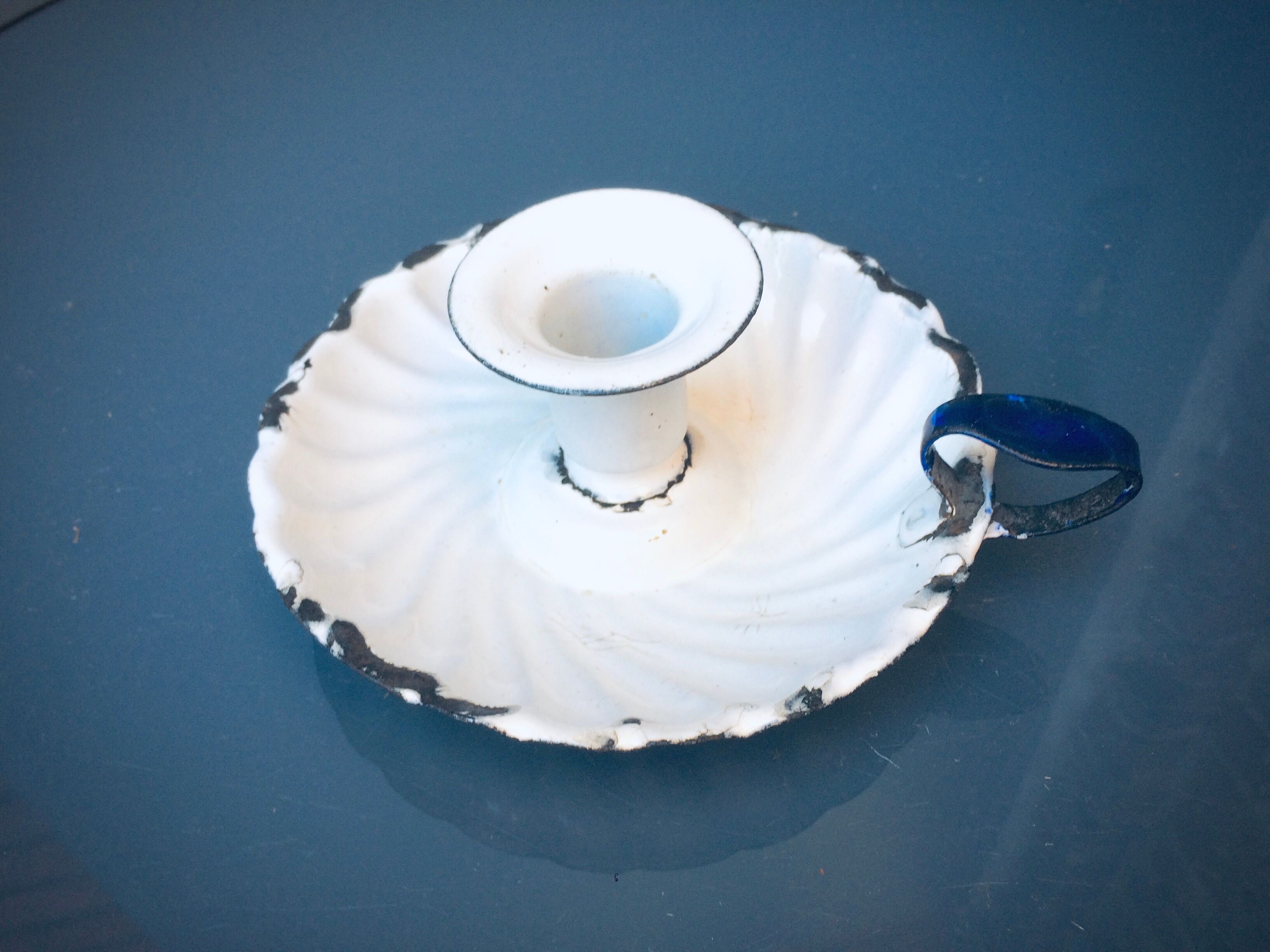 Old white enamelled candlestick