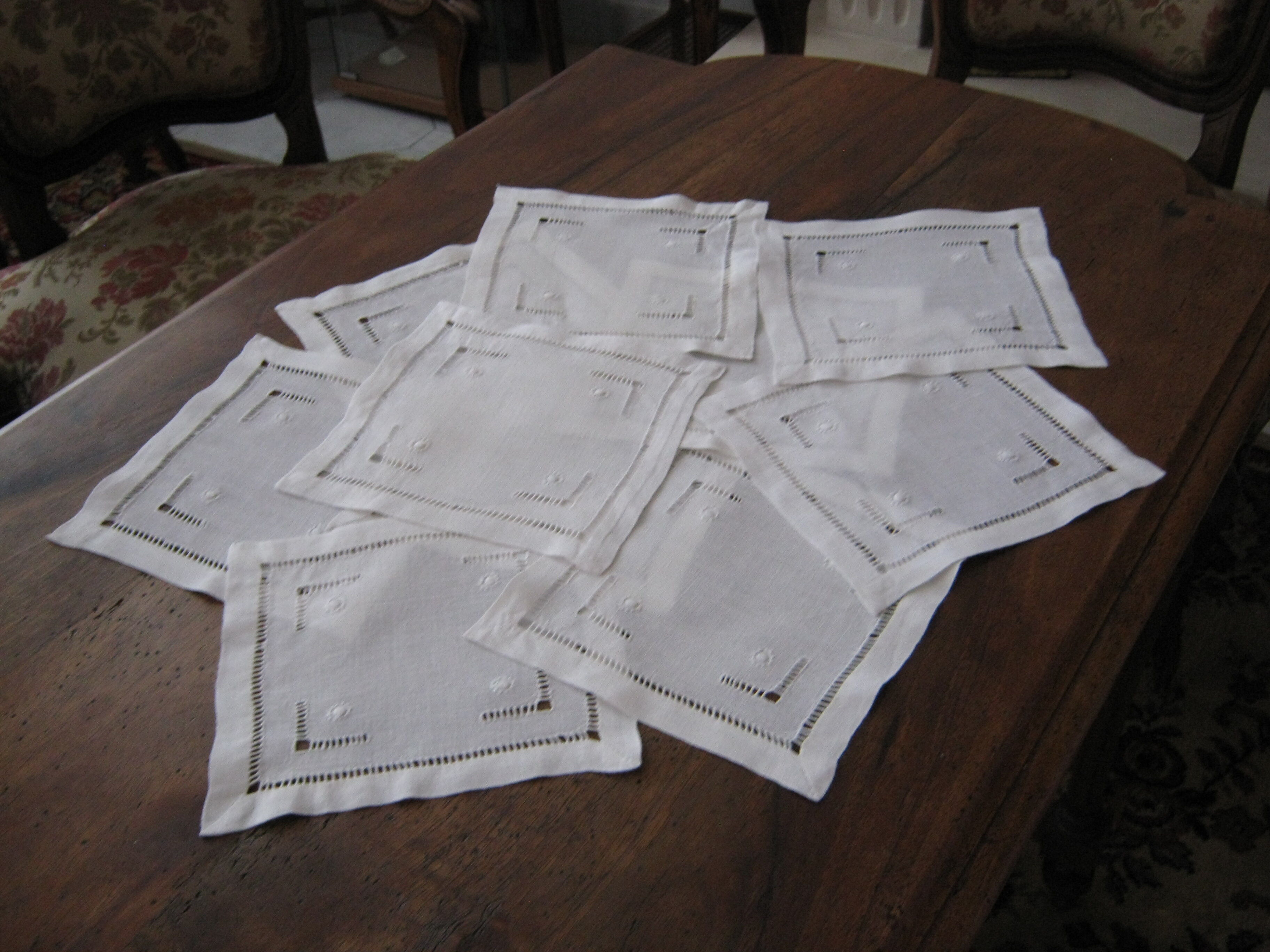 Under glass / small hand embroidered white cotton doilies