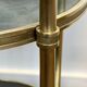 Round bronze side table with triple shelves of églomisé mirrors from Maison Baguès