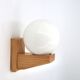 Wall light in pine wood with opaque white glass globe, 1980s