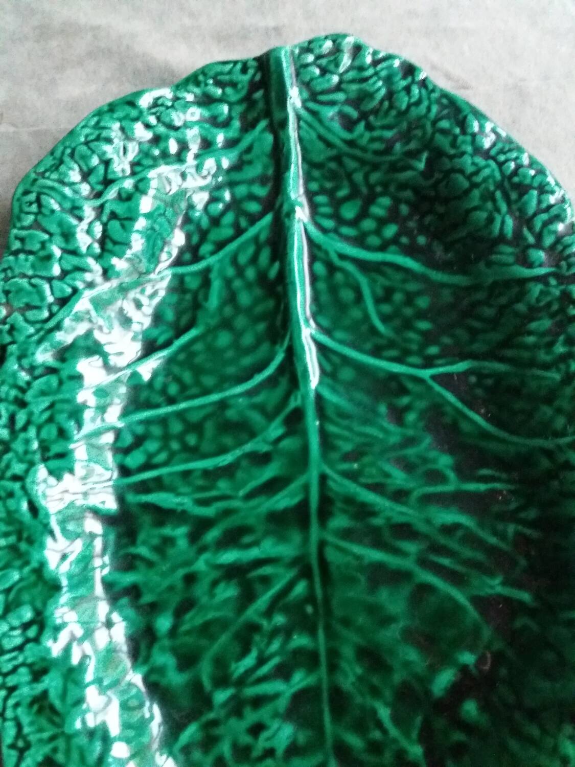 Large dish in green cabbage leaf slip
