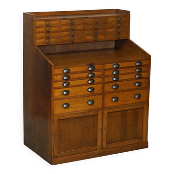 Antique English Art Deco furniture in hand-carved oak, 26 drawers.