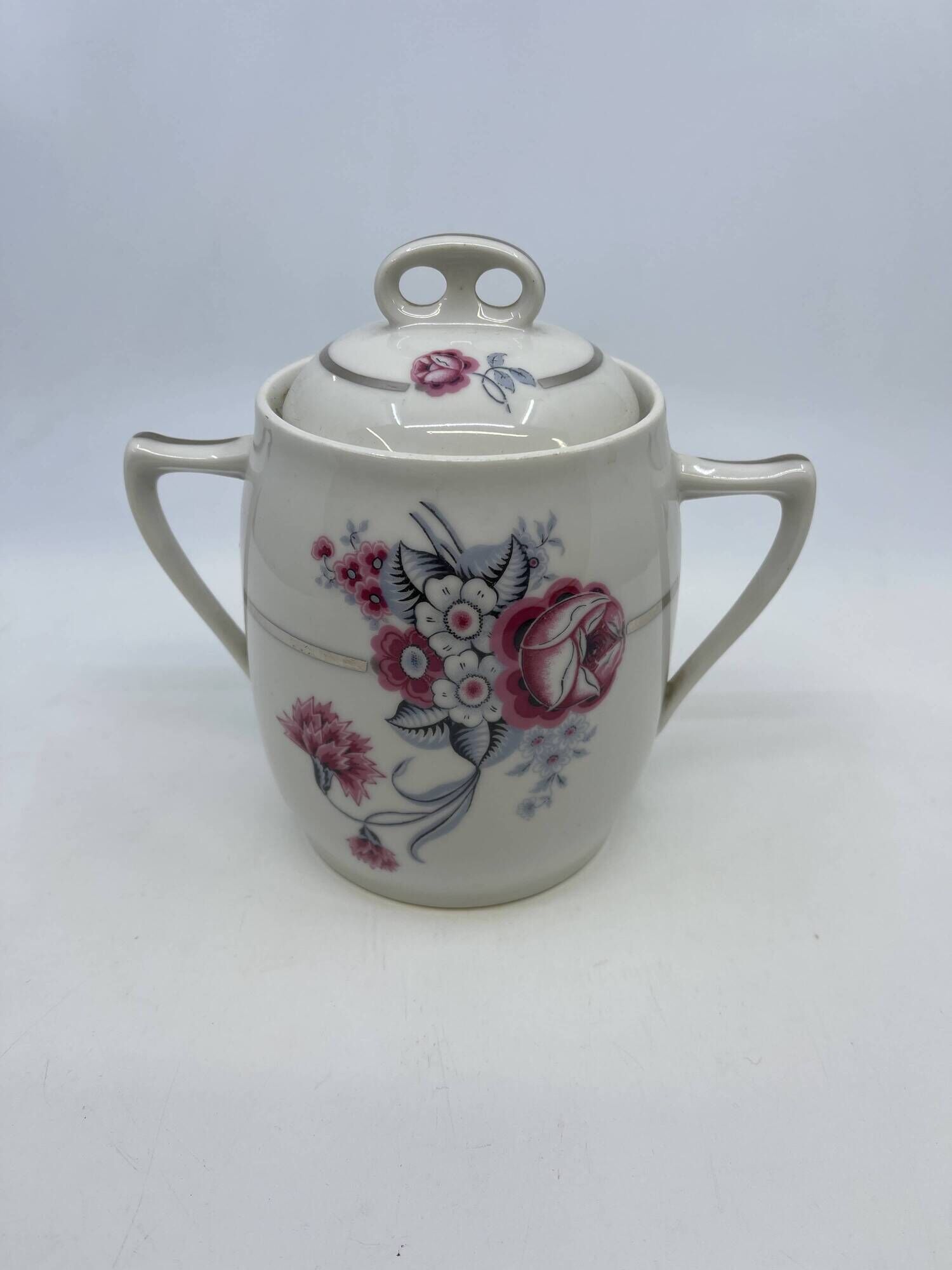 Porcelain coffee service with floral decoration and silver trim.