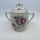 Porcelain coffee service with floral decoration and silver trim.