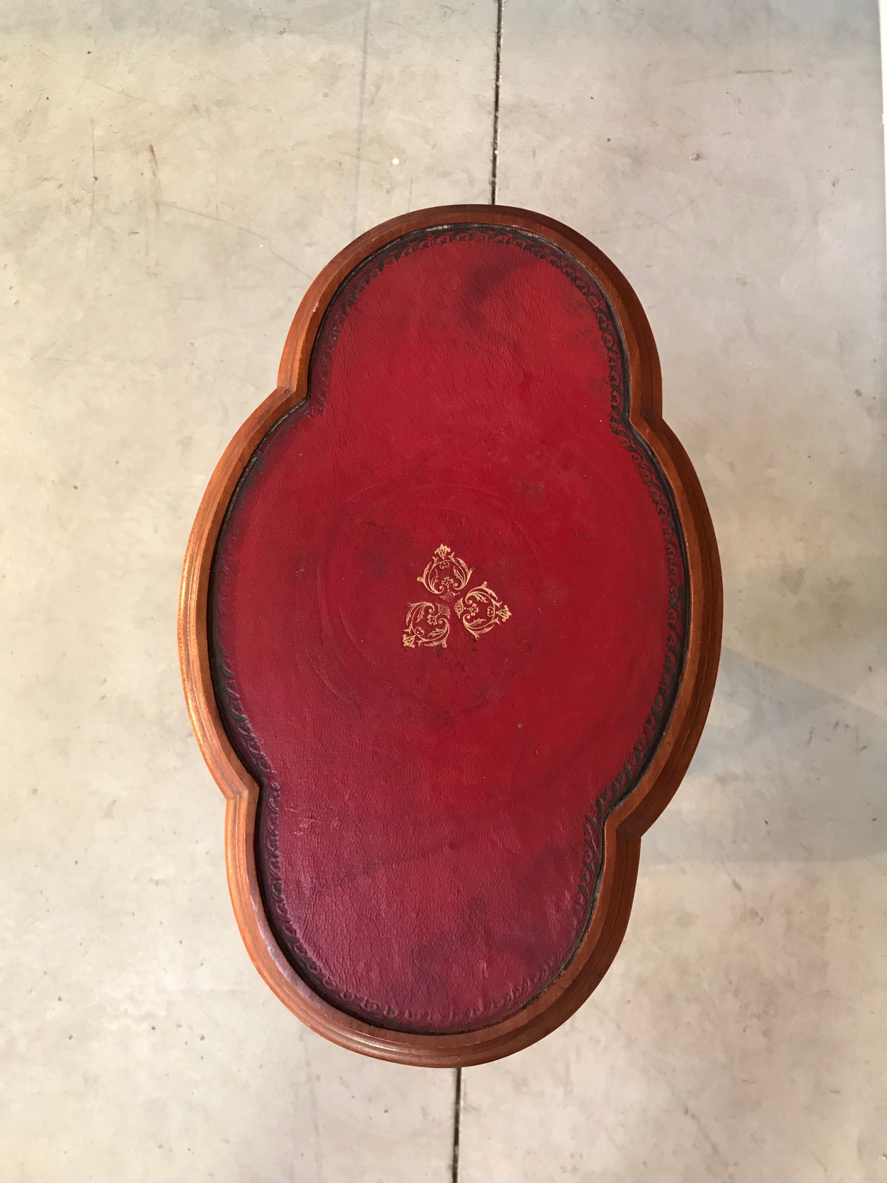 Wooden pedestal table red leather top