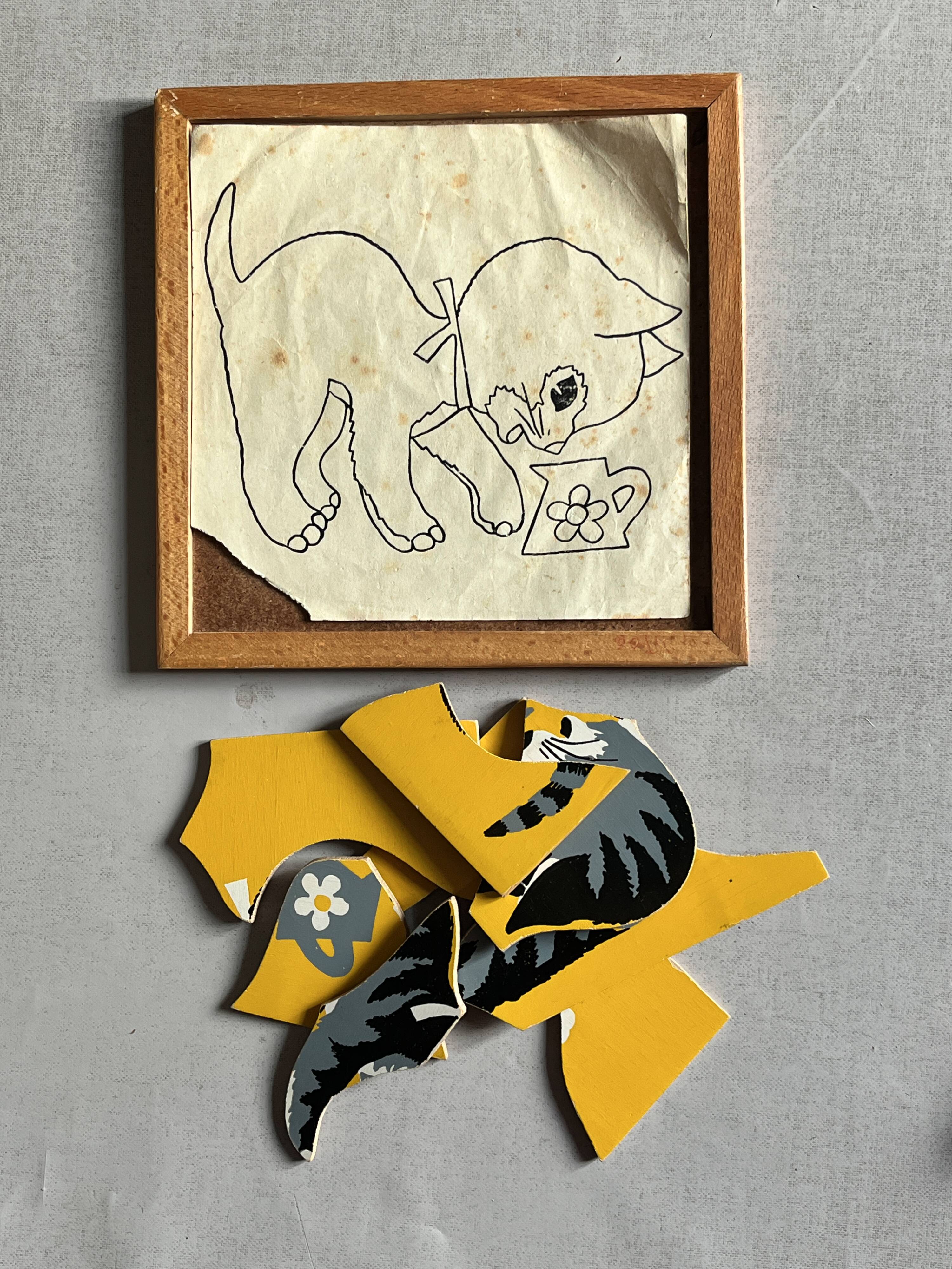 Wooden frame puzzle from the 1940s/50s depicting a cat on a yellow background.