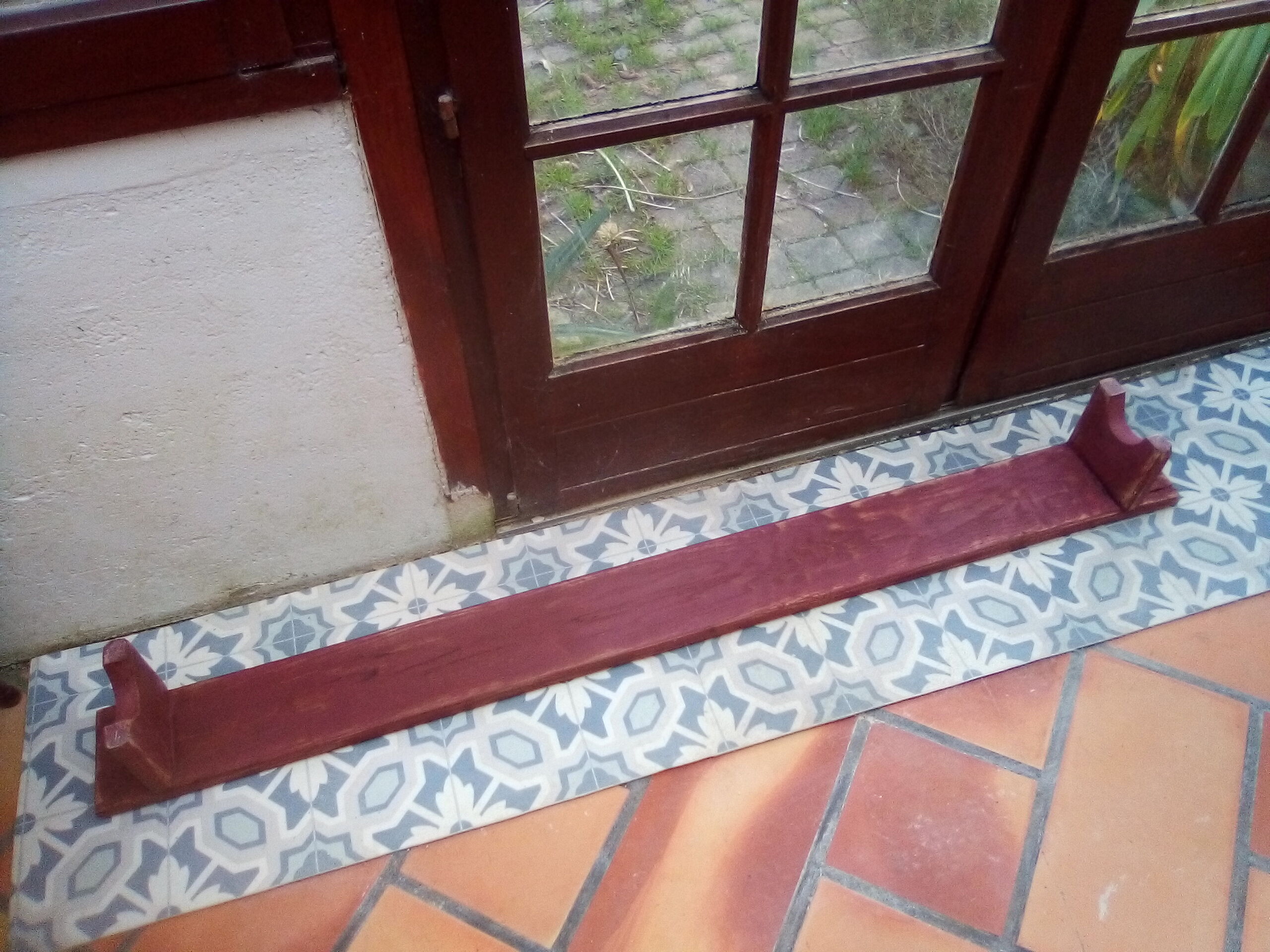 Low bench rests feet in patinated wood
