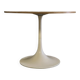 Mid-century round tulip dining table with a wooden top, vintage 1970s design.