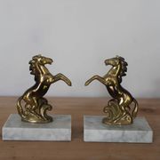 Pair of vintage bookends with rearing horses in gilded metal on marble bases.