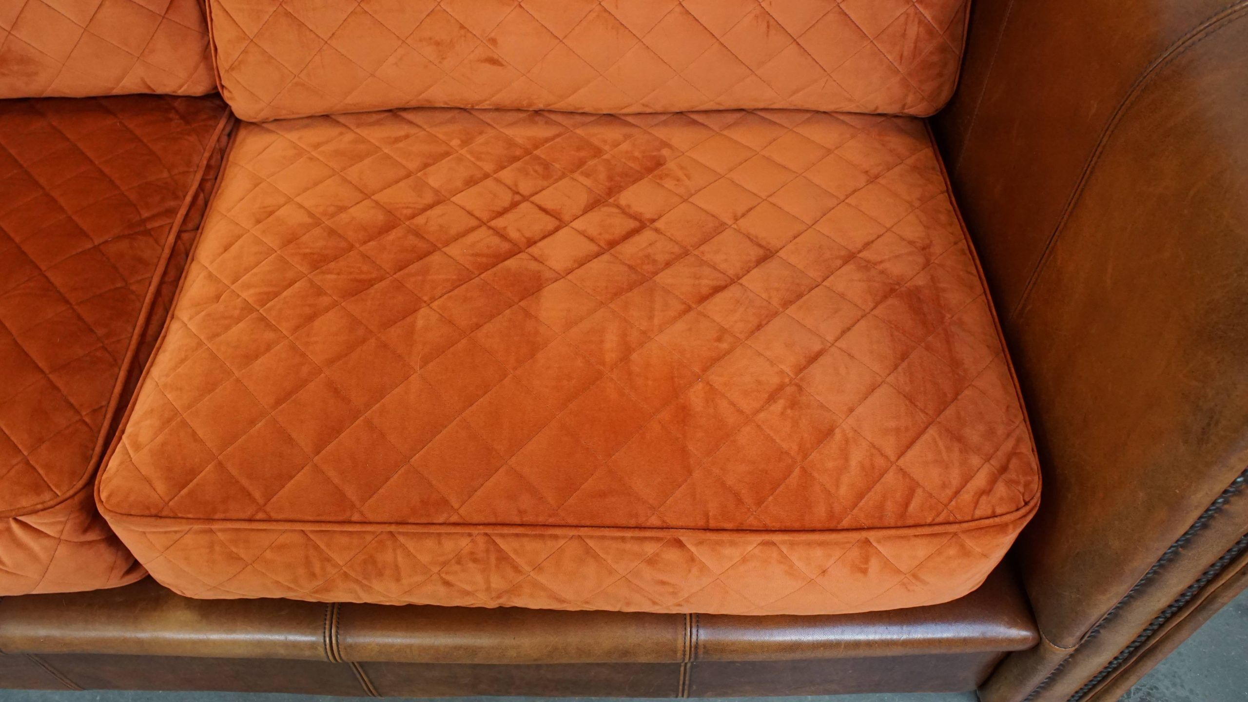 Luxury and comfortable sheepskin 2.5-seater sofa of top quality with orange fabric seat and back cushions