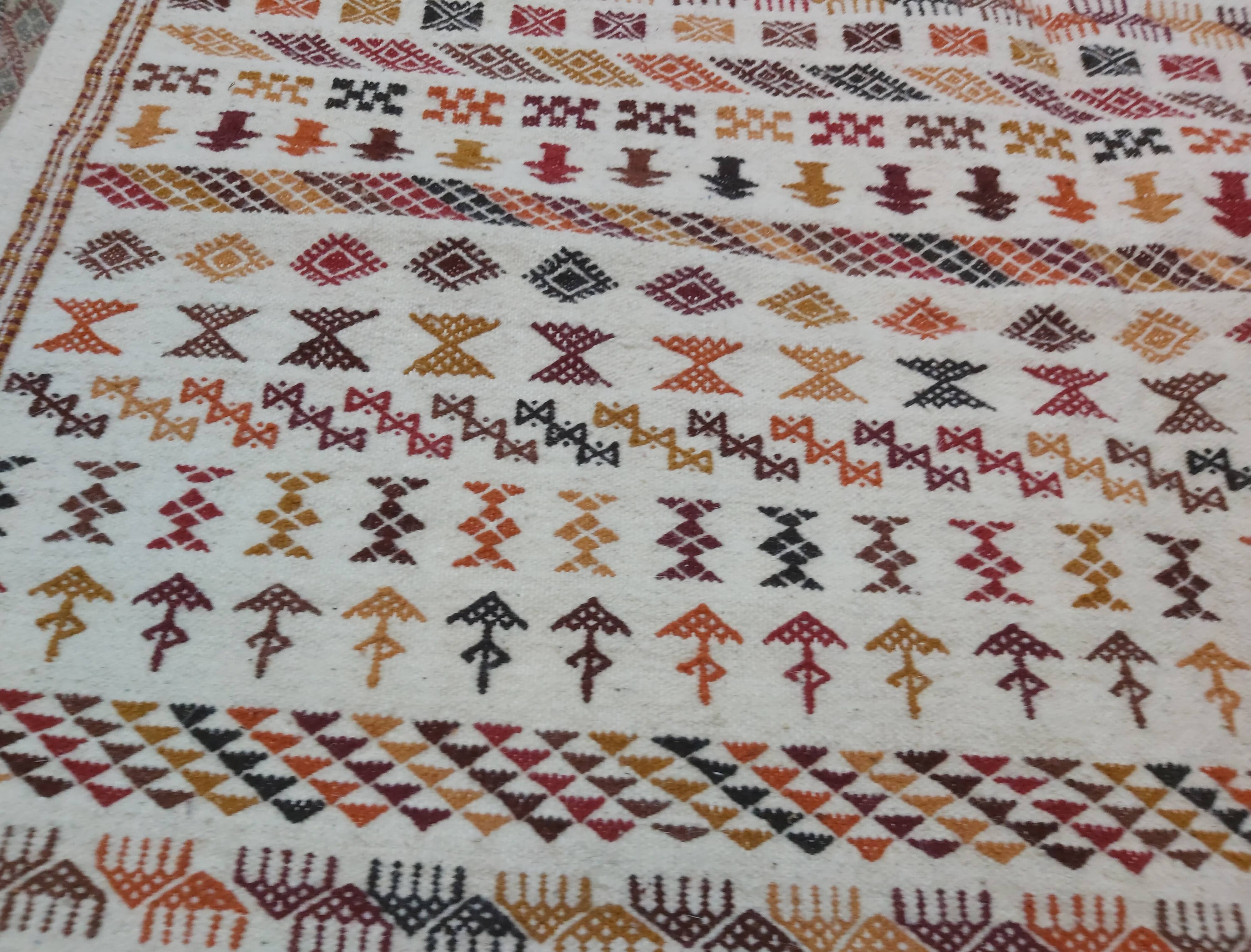 White carpet with multicolored Berber patterns