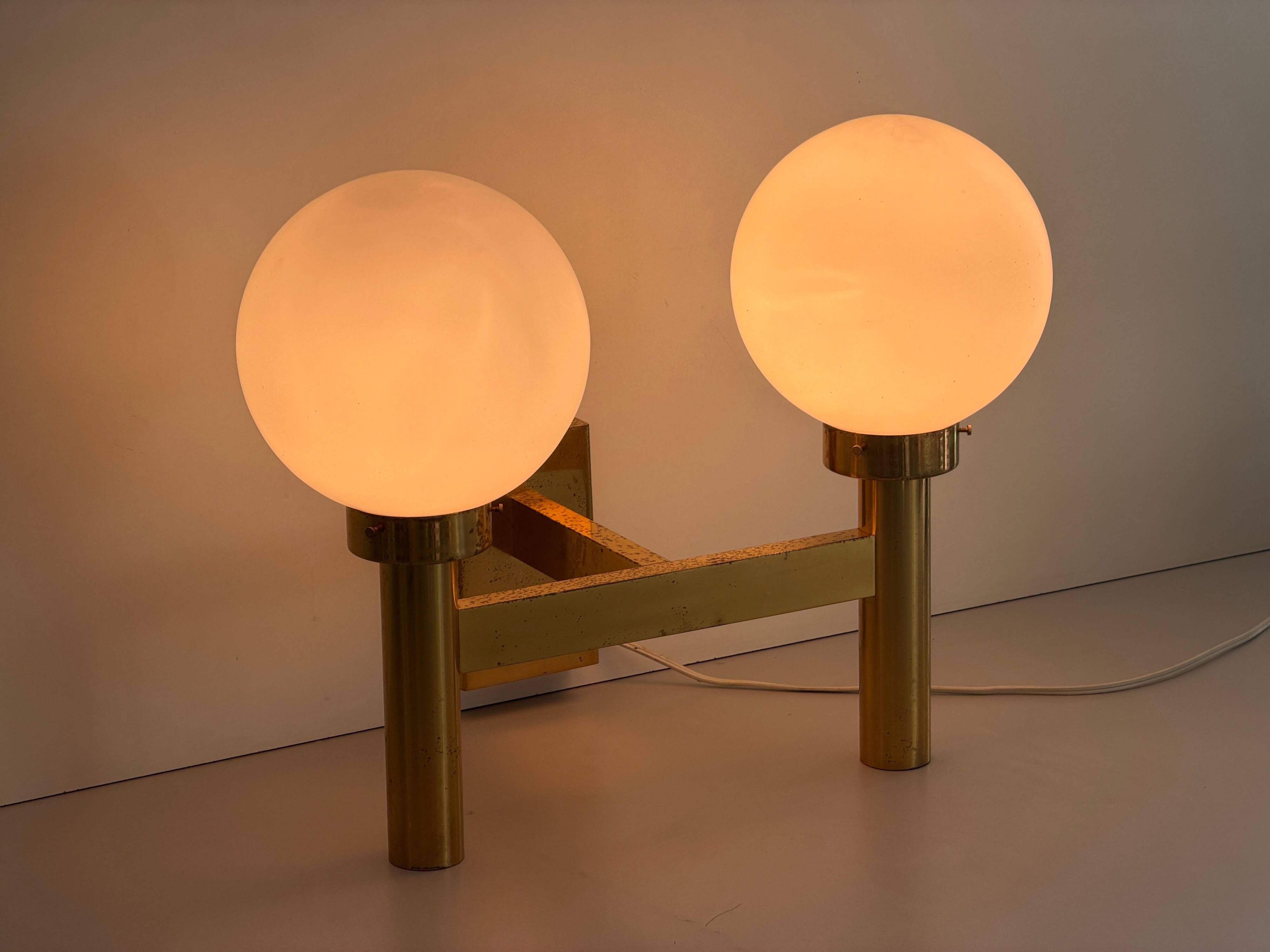 Double opal glass and heavy brass, large minimalist cinema wall light, 1960s, Germany